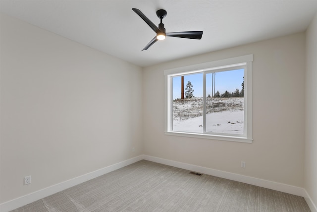 unfurnished room featuring light carpet and ceiling fan