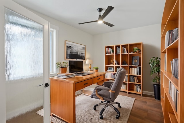 office space with dark wood-type flooring and ceiling fan