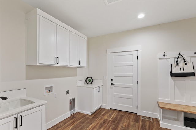 washroom with dark wood-type flooring, sink, cabinets, electric dryer hookup, and washer hookup