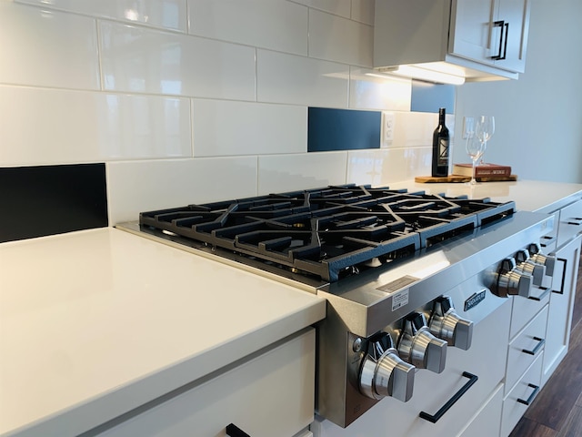 details featuring tasteful backsplash and stove