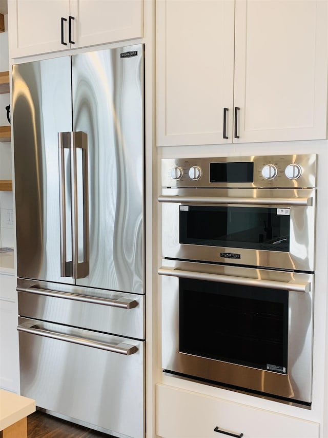 kitchen with appliances with stainless steel finishes and white cabinets