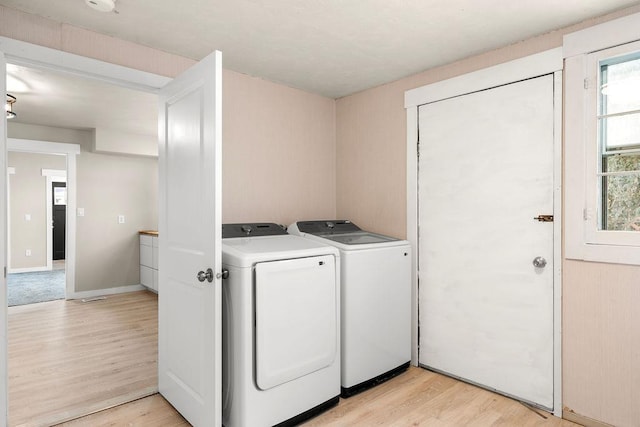 washroom featuring separate washer and dryer and light wood-type flooring