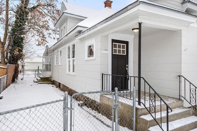 view of snow covered property entrance