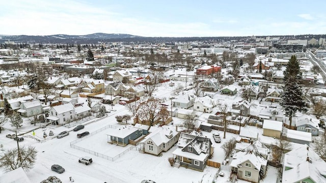 snowy aerial view with a mountain view