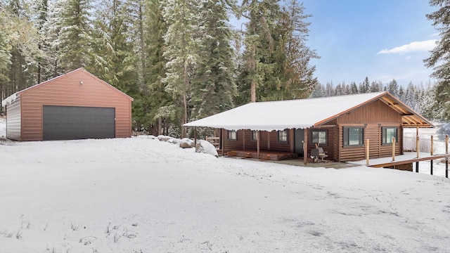 view of front of home with a garage and an outbuilding