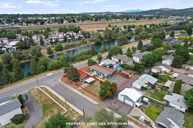 drone / aerial view with a water and mountain view