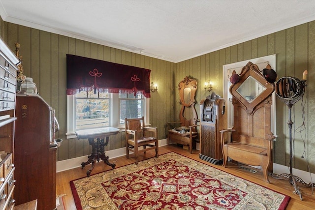 sitting room featuring hardwood / wood-style flooring and ornamental molding