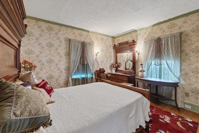 bedroom with hardwood / wood-style flooring and a textured ceiling