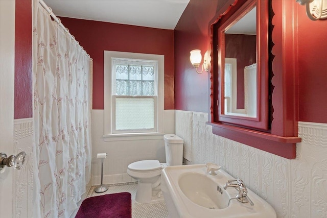 bathroom featuring sink, tile patterned floors, and toilet