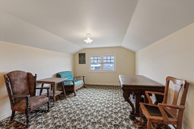 sitting room featuring carpet flooring and vaulted ceiling