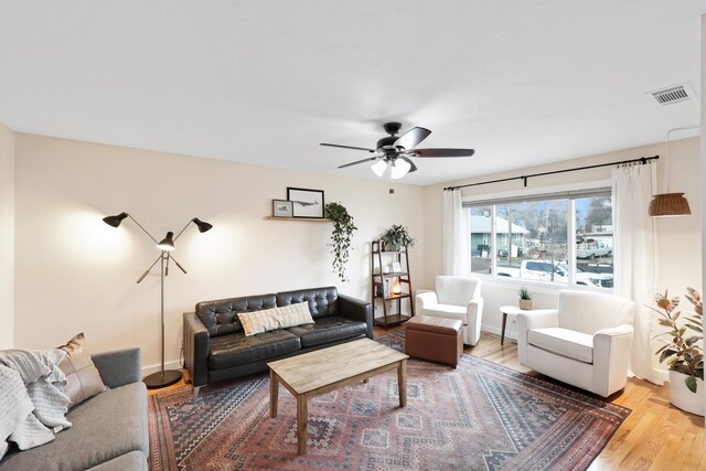 living room featuring ceiling fan and wood-type flooring