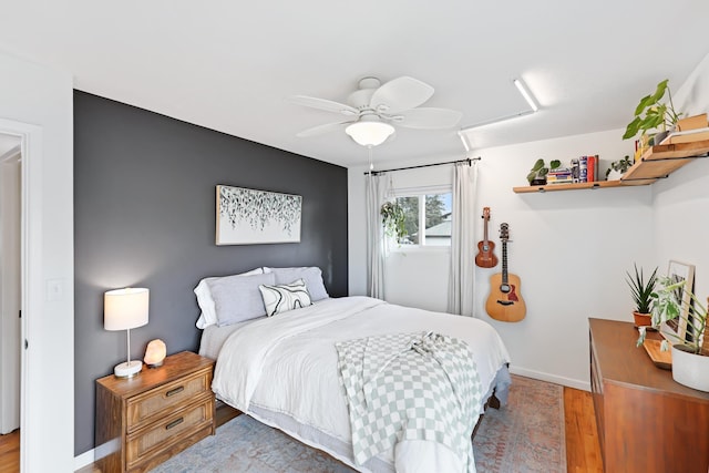 bedroom with hardwood / wood-style flooring and ceiling fan