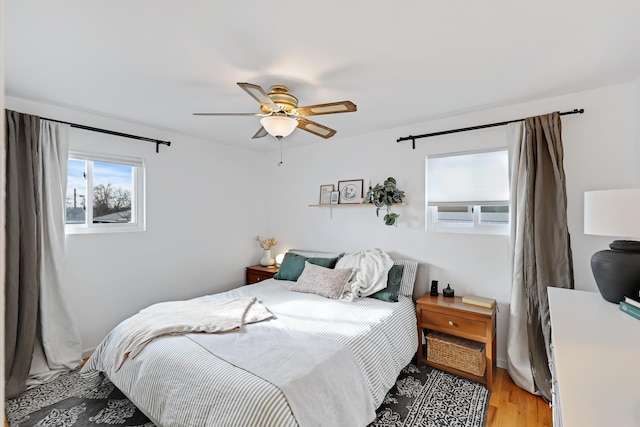 bedroom with ceiling fan and wood-type flooring