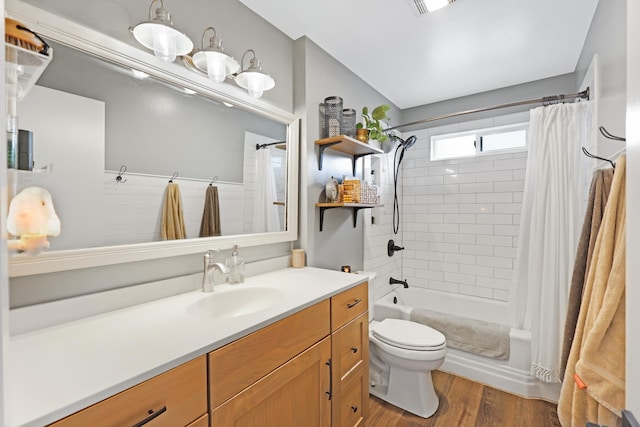 full bath with visible vents, toilet, wood finished floors, vanity, and shower / bathtub combination with curtain