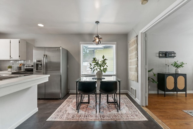 dining area with dark hardwood / wood-style flooring and sink