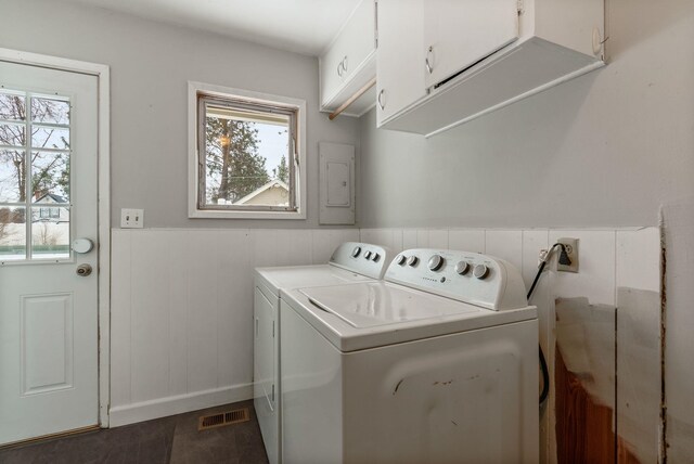 clothes washing area featuring cabinets, a healthy amount of sunlight, and independent washer and dryer