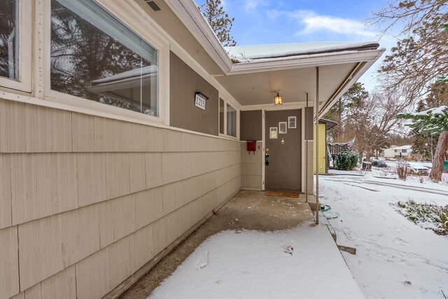 view of snow covered property entrance