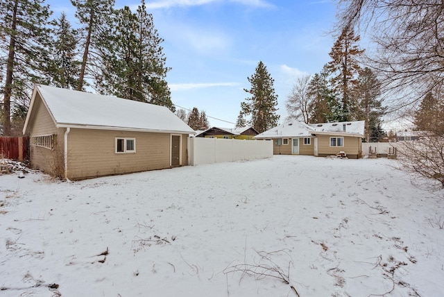 view of snow covered back of property