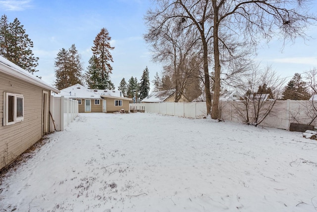 view of yard layered in snow