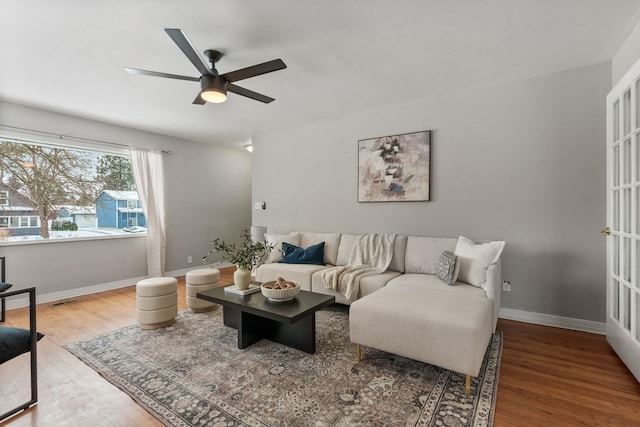 living room with hardwood / wood-style flooring and ceiling fan