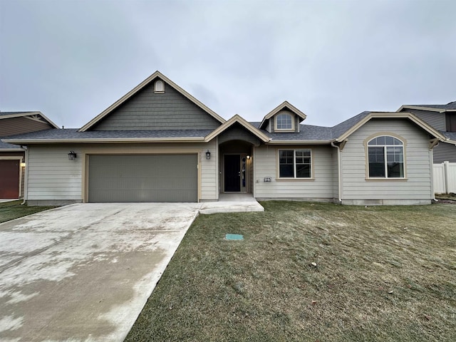 view of front of house with a garage and a front yard