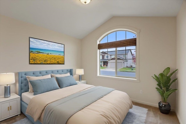 carpeted bedroom featuring lofted ceiling