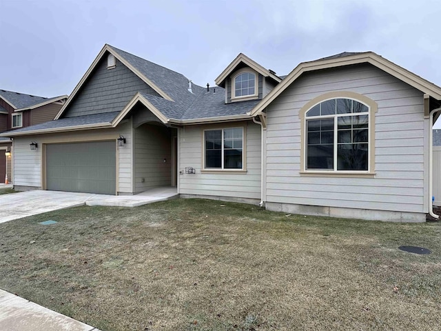 view of front of property with a garage and a front lawn