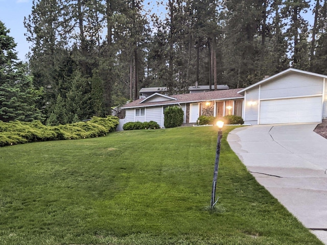 ranch-style home with a garage and a front yard