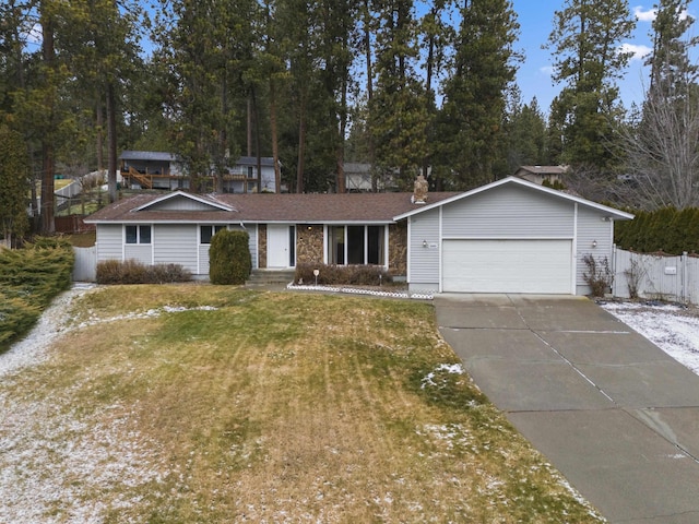 ranch-style home with a garage and a front yard