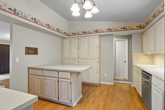 kitchen featuring lofted ceiling, hanging light fixtures, tasteful backsplash, light hardwood / wood-style floors, and stainless steel dishwasher