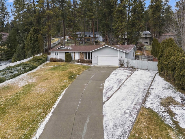 single story home featuring a garage and a front yard