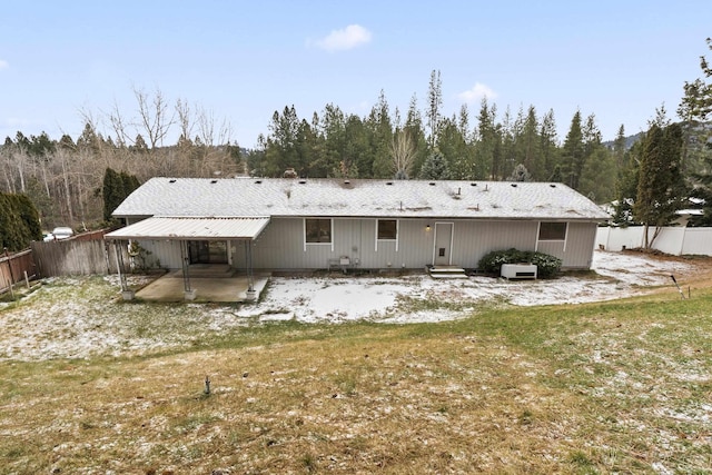 rear view of house featuring a patio and a lawn