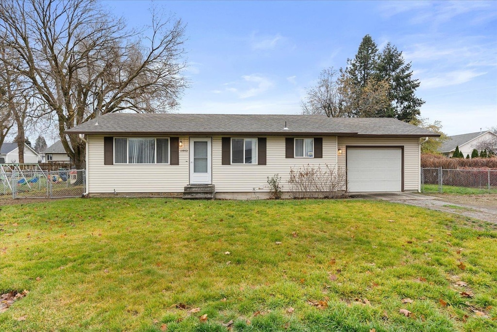 single story home featuring a garage and a front yard