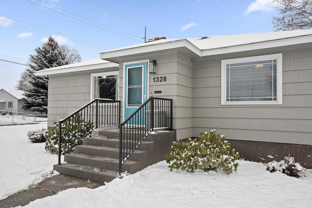 view of snow covered property entrance