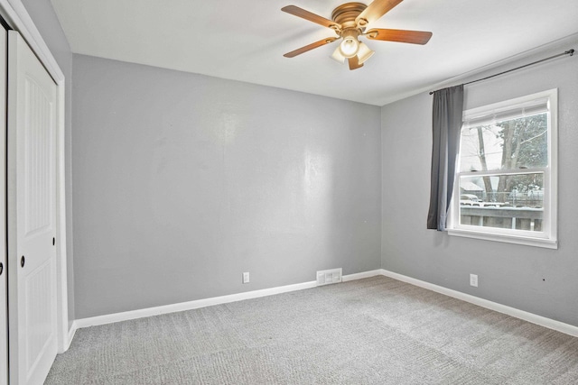 unfurnished bedroom featuring carpet floors, a closet, and ceiling fan