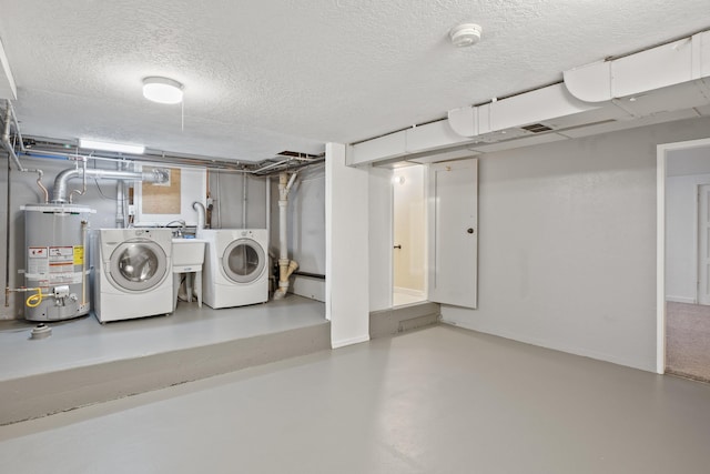 laundry room with washing machine and clothes dryer, a textured ceiling, and gas water heater