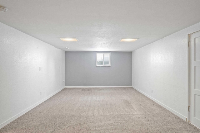 basement with carpet floors and a textured ceiling