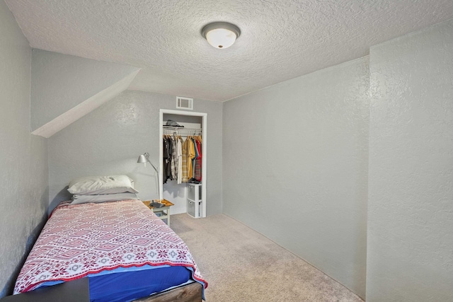 carpeted bedroom featuring a textured ceiling