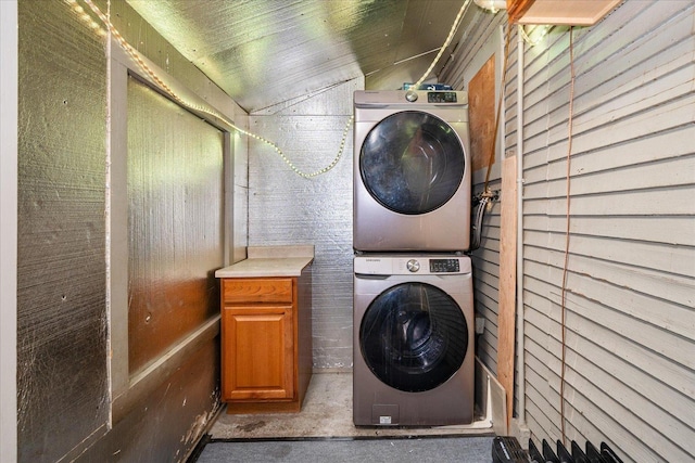 laundry room with stacked washer and clothes dryer