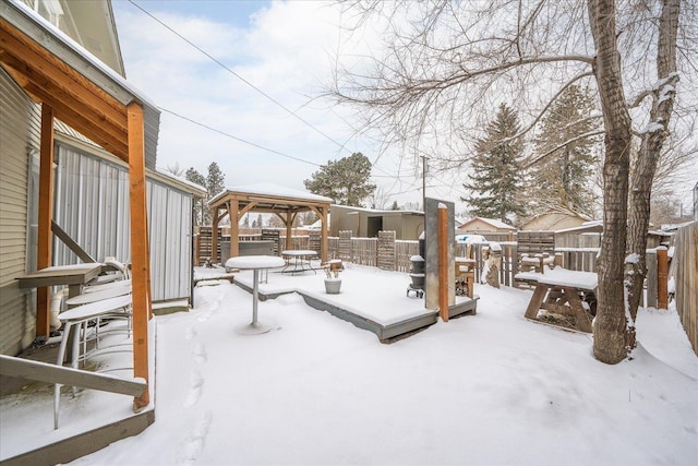 snow covered patio featuring a gazebo