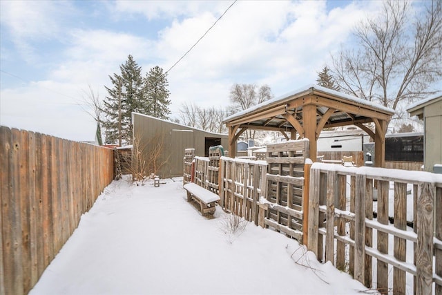 yard layered in snow with a gazebo