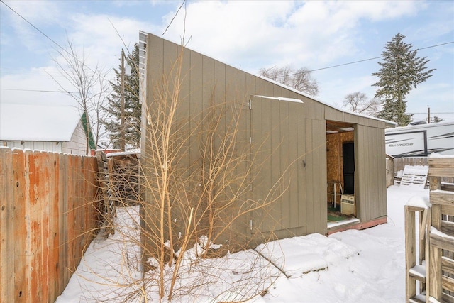 view of snowy exterior with an outdoor structure