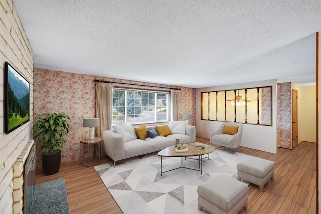 living room featuring light hardwood / wood-style flooring and a textured ceiling