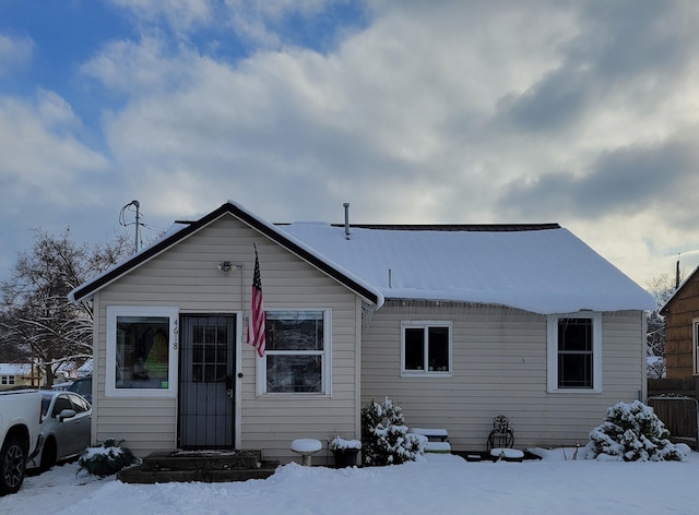 view of snow covered back of property