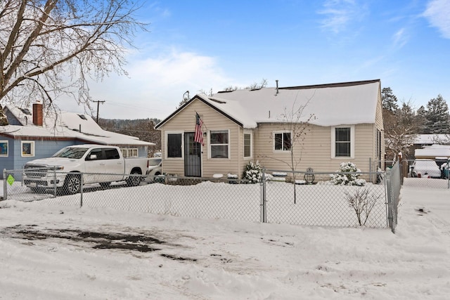 view of snow covered back of property