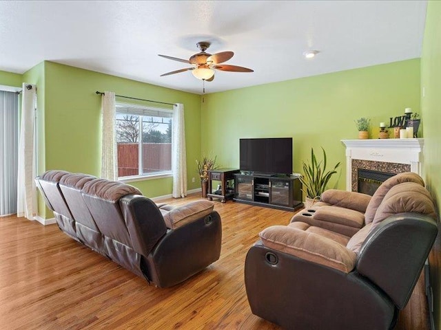 854 S Shelley Lake Ln, Spokane Valley, WA 99037 - living area with baseboards, a ceiling fan, wood finished floors, and a high end fireplace