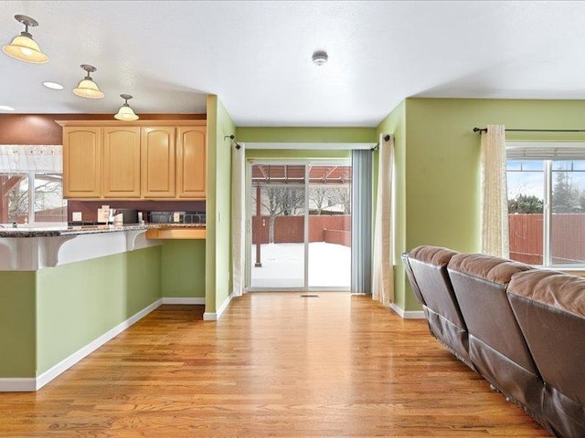 854 S Shelley Lake Ln, Spokane Valley, WA 99037 - kitchen with light wood finished floors, plenty of natural light, baseboards, and light brown cabinetry