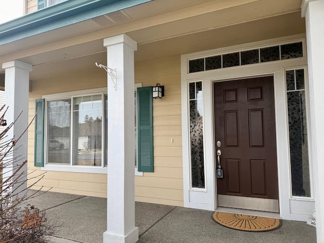 view of exterior entry with covered porch