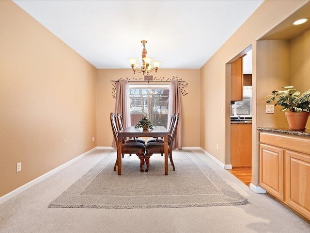 854 S Shelley Lake Ln, Spokane Valley, WA 99037 - dining area with a chandelier, light carpet, and baseboards