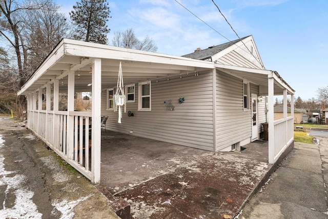 view of side of property with a carport